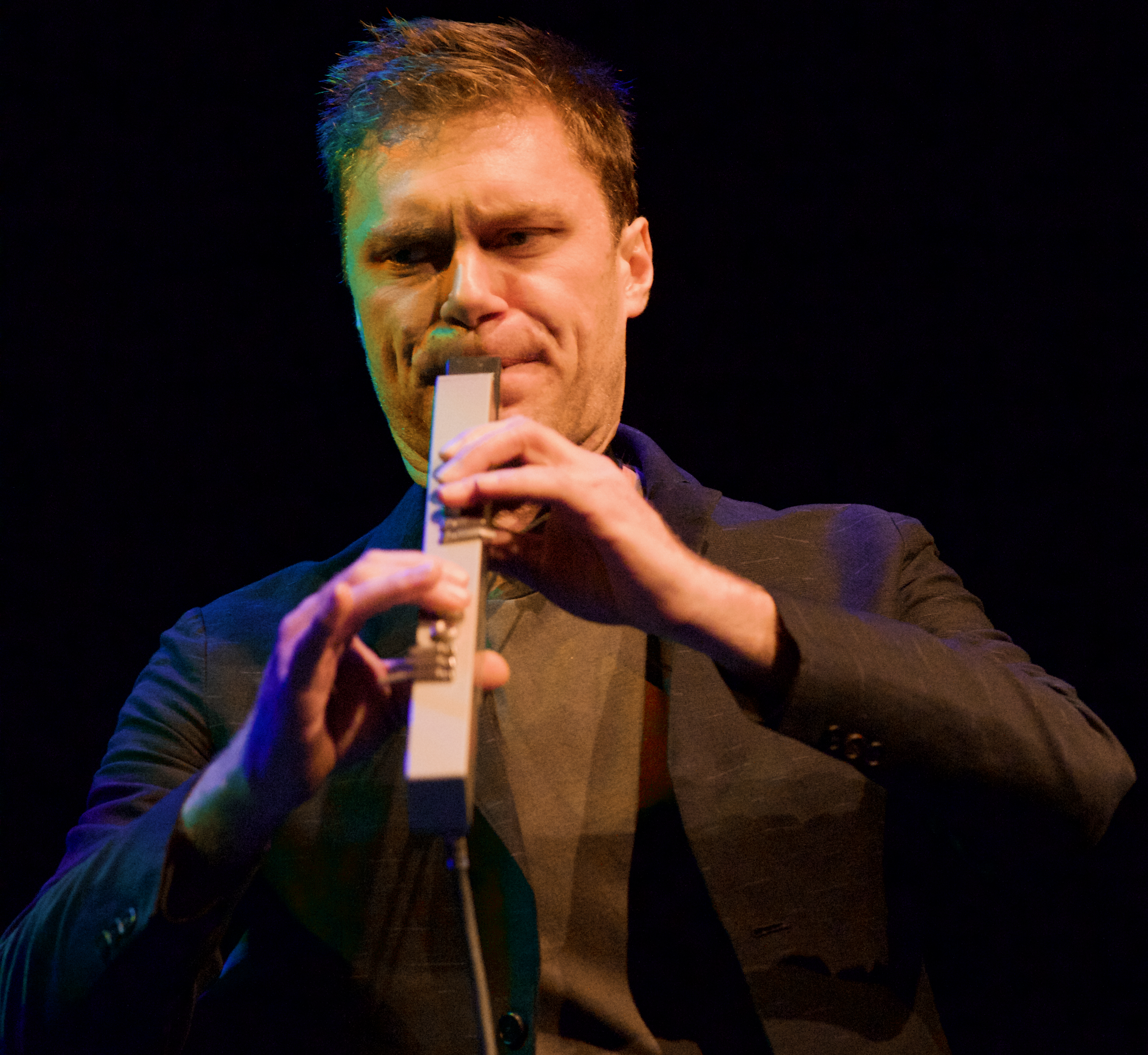 Musician Chase Baird playing an Akai EWI1000 during a 2019 performance