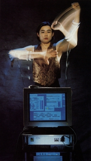 Atau Tanaka performing with BioMuse, wearing electrode armbands on forearms and biceps