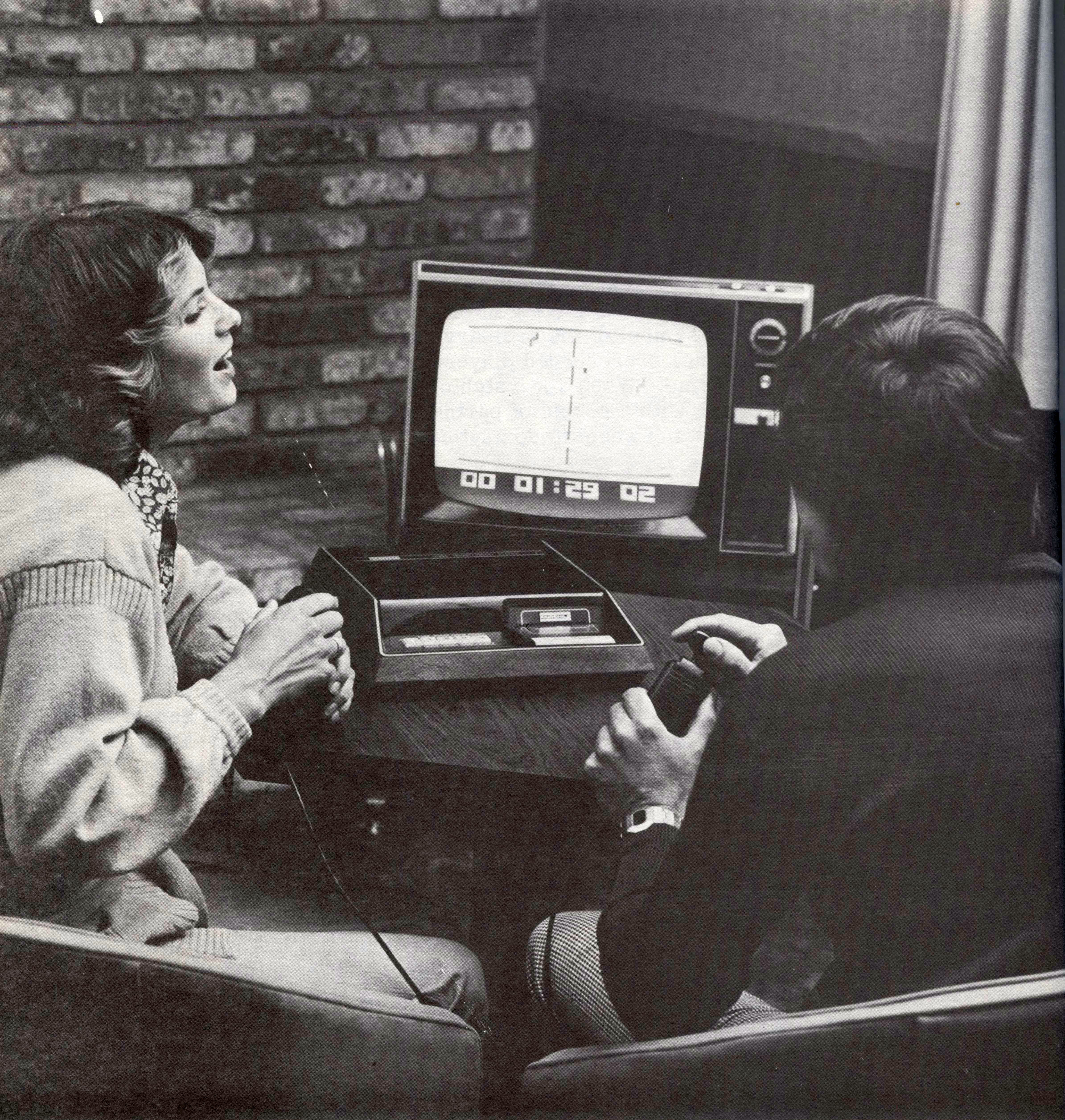 Period photo of two people playing the Fairchild Channel F