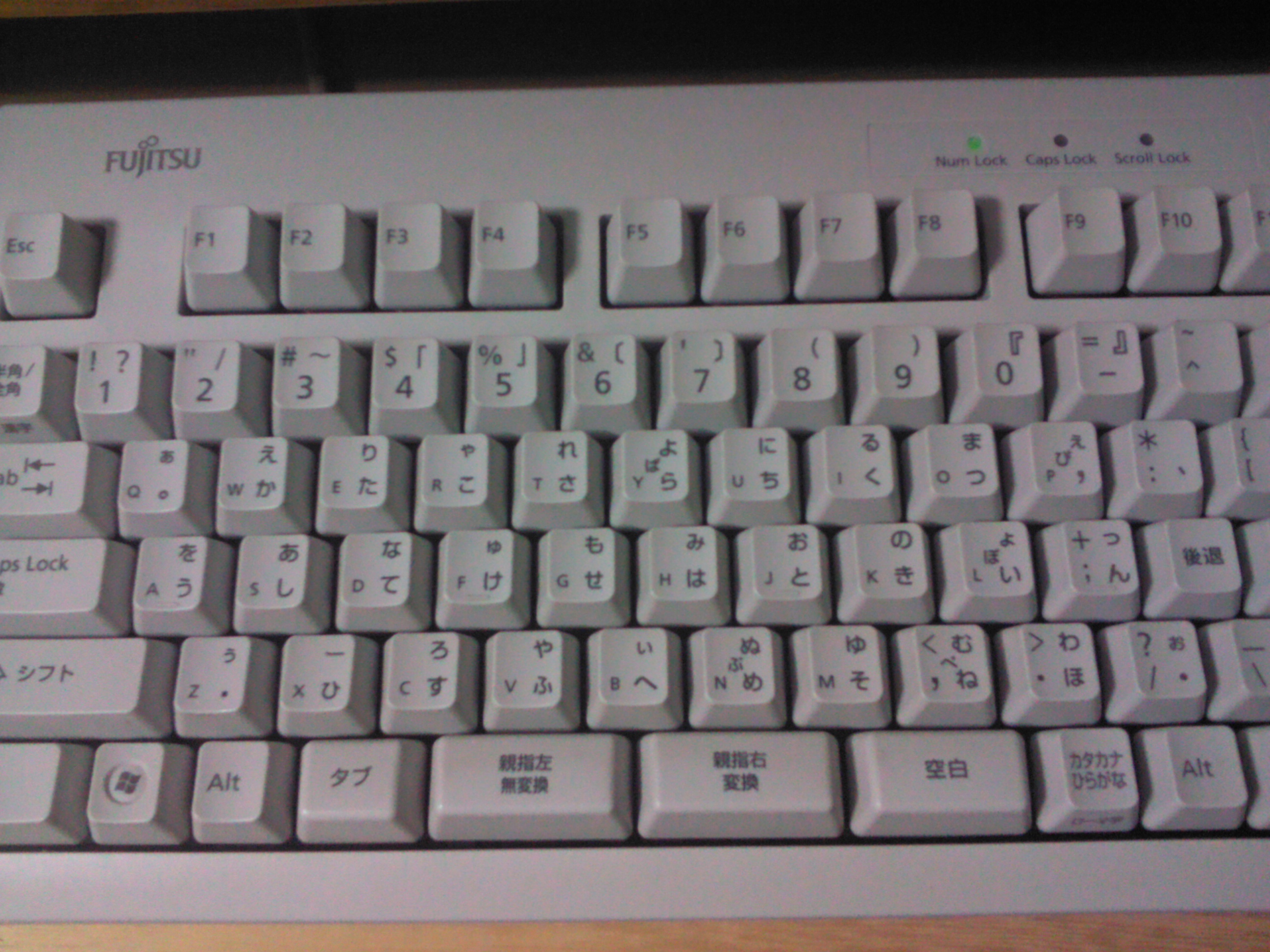 A physical thumb-shift keyboard with the two thumb-shift keys at bottom center