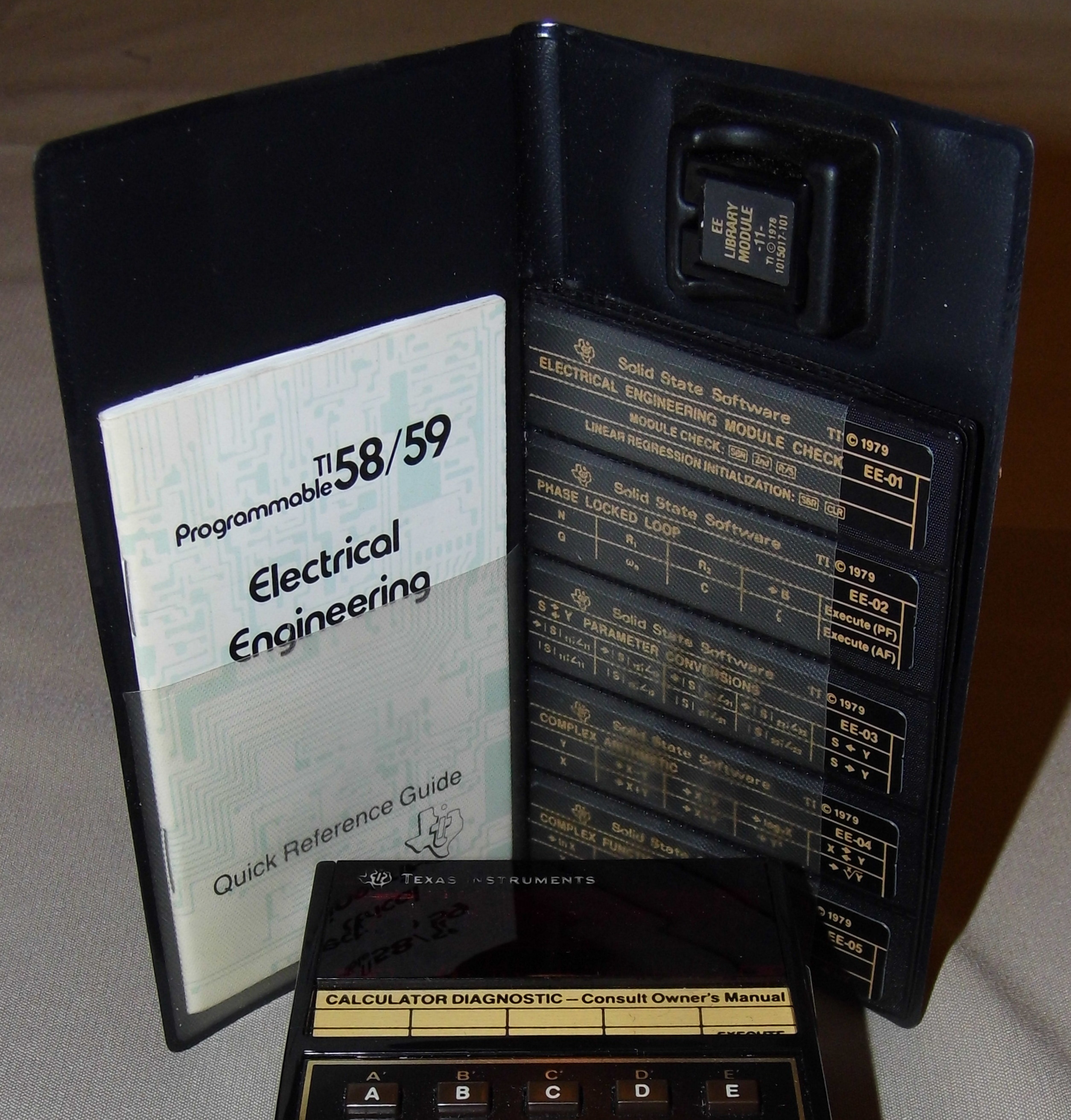TI-59 Solid State Software module with its plastic key-overlay cards